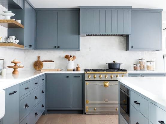Kitchen with blue-grey shaker cabinets, open shelving and a freestanding range